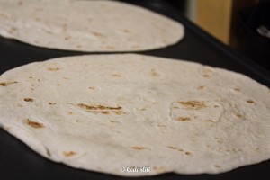 Warm up your flour tortillas on the flat griddle or a pan (you can zap the whole bag in the microwave for 30 seconds) before rolling your burrito for best results. 